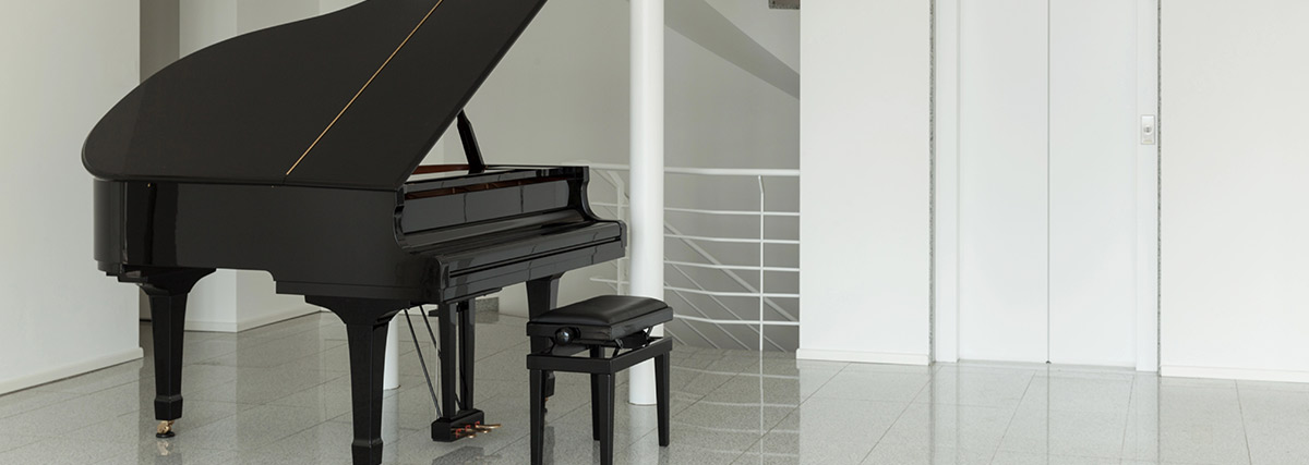 A black grand piano in a white room