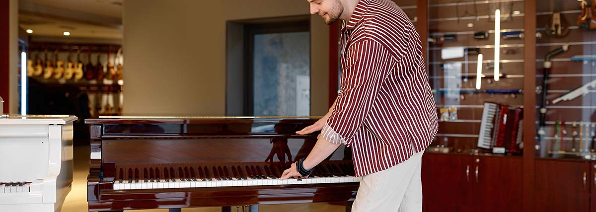 A man testing a piano in a shop