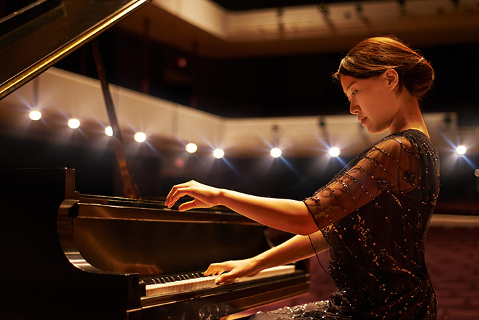 Asian lady playing classical piano