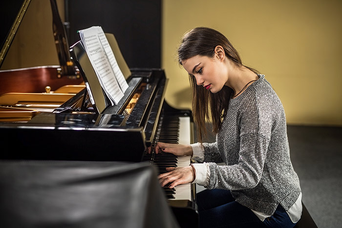 Beautiful lady playing piano