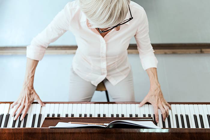 Beginner student learning how to learn a score on the piano
