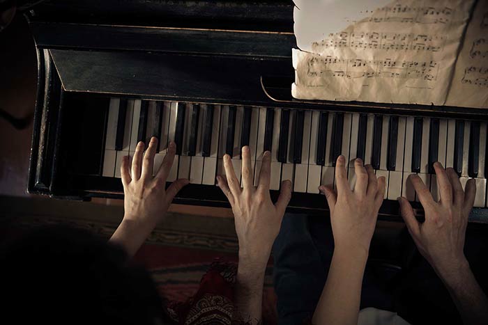 Couple taking a group piano lesson together