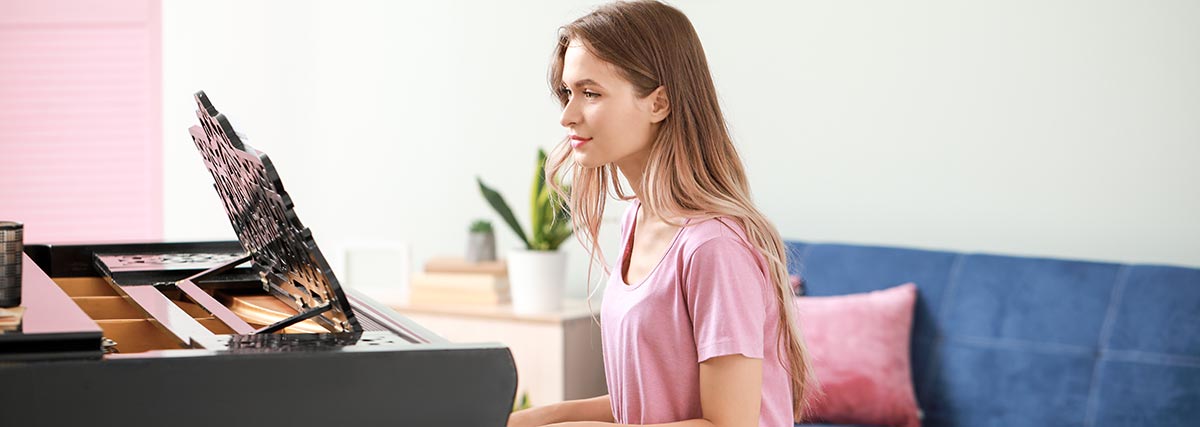 female practising piano at home