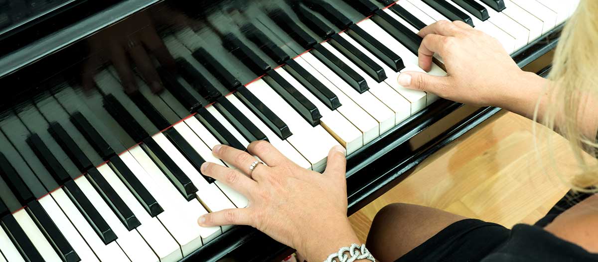 Hands of a woman playing on piano
