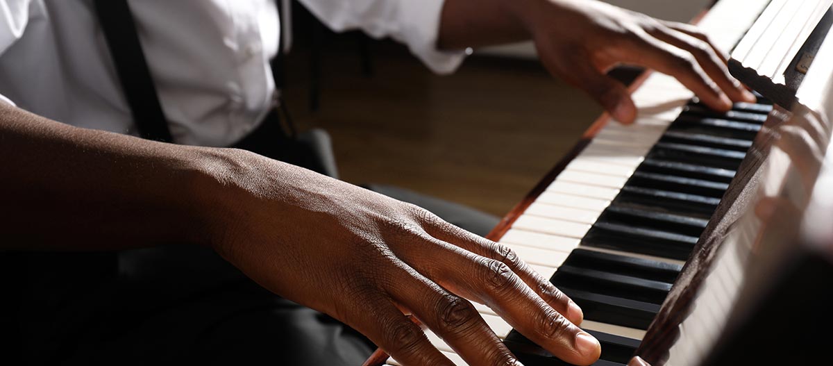 Hands of jazz pianist on the piano keyboards