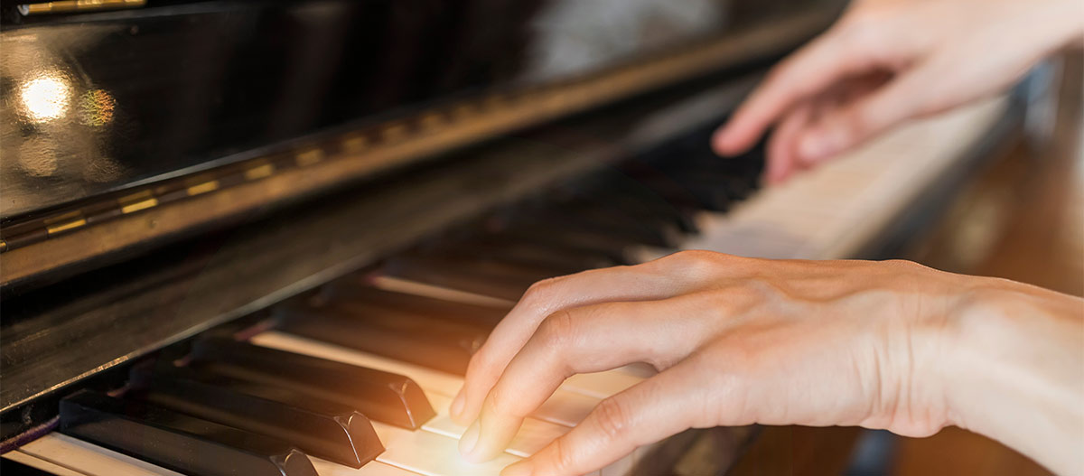 Hands on piano keyboard