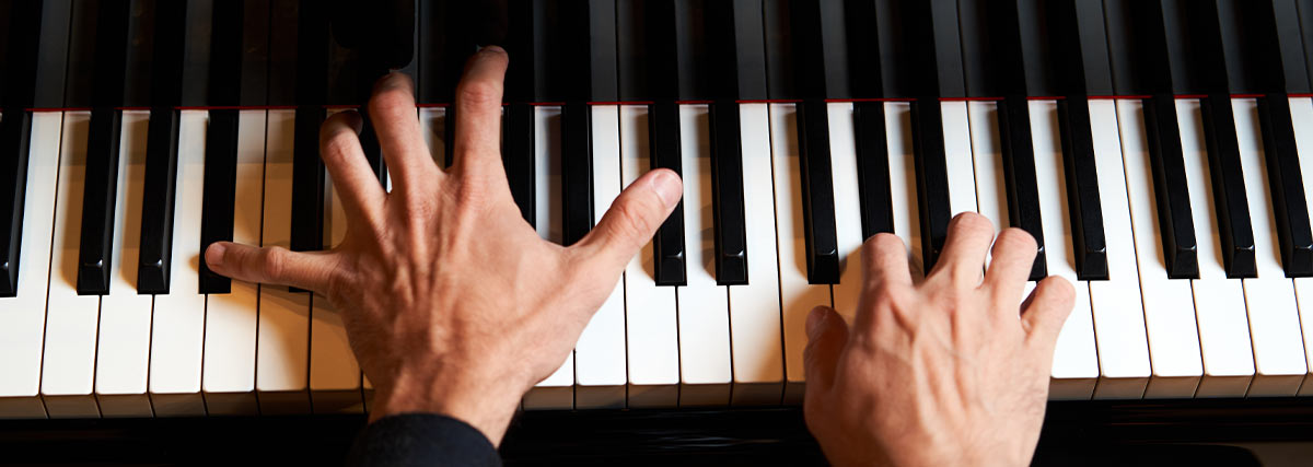 Hands on piano keyboard