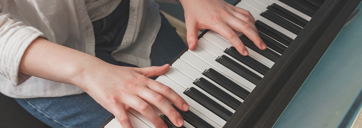 Hands on piano keyboard