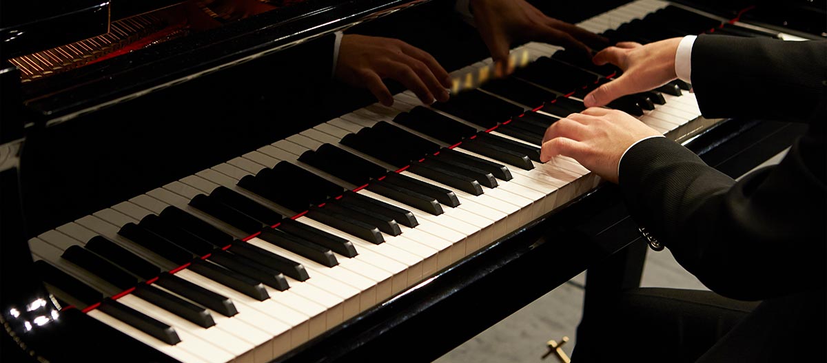 Hands on piano keyboard