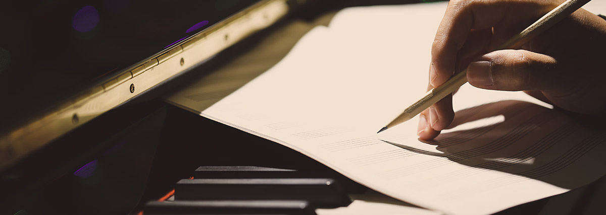 Hands writing on the notes