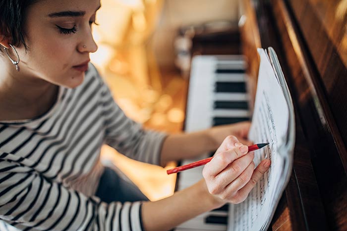 Lady composing at the piano