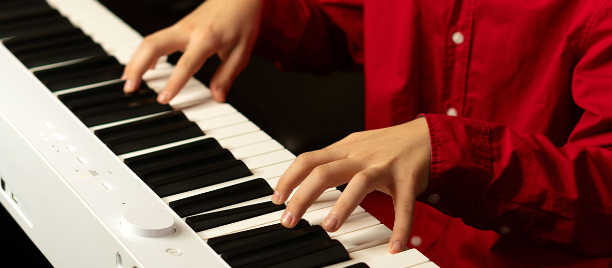 Lady hands on digital piano keyboard