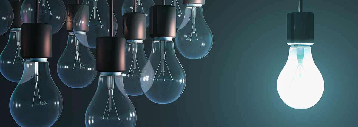 Light bulb standing out from the others bulbs and lit