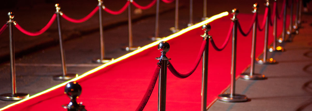 Long red carpet between rope barriers on entrance
