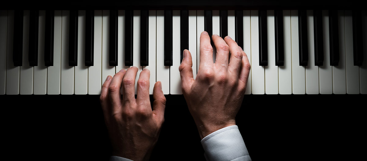 Male hands on piano keyboard