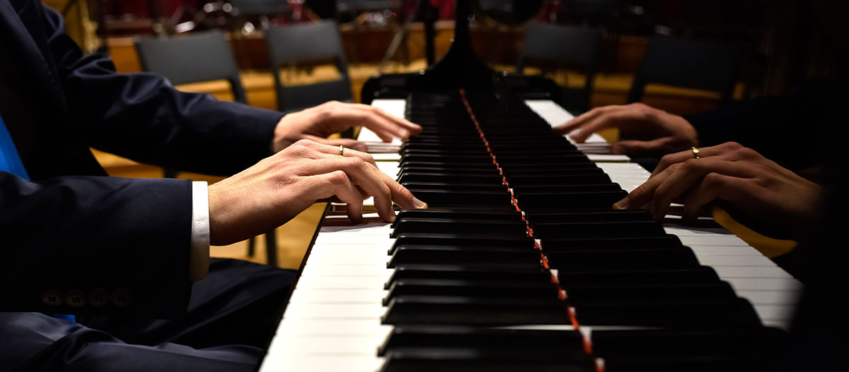 Male hands playing the piano
