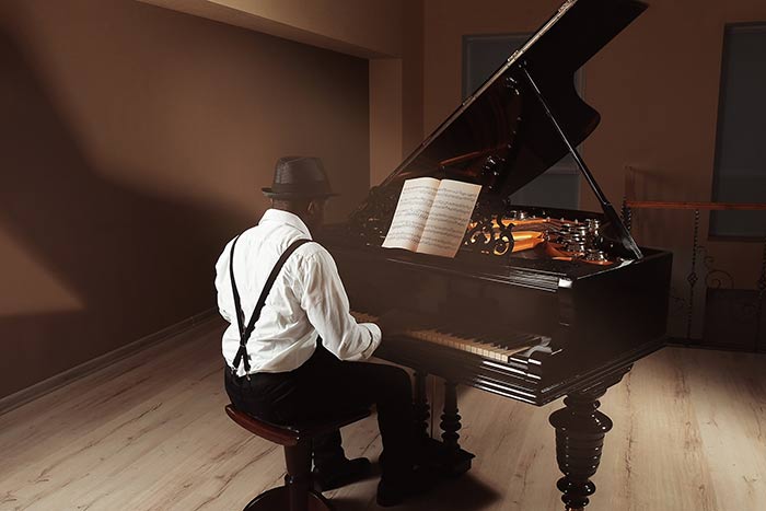 male playing the piano feat