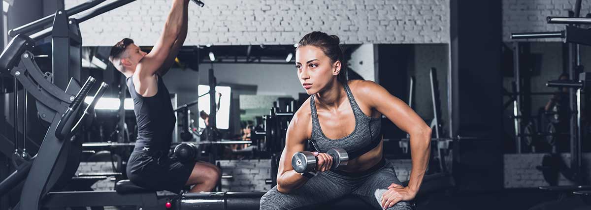 man and woman working out in the gym