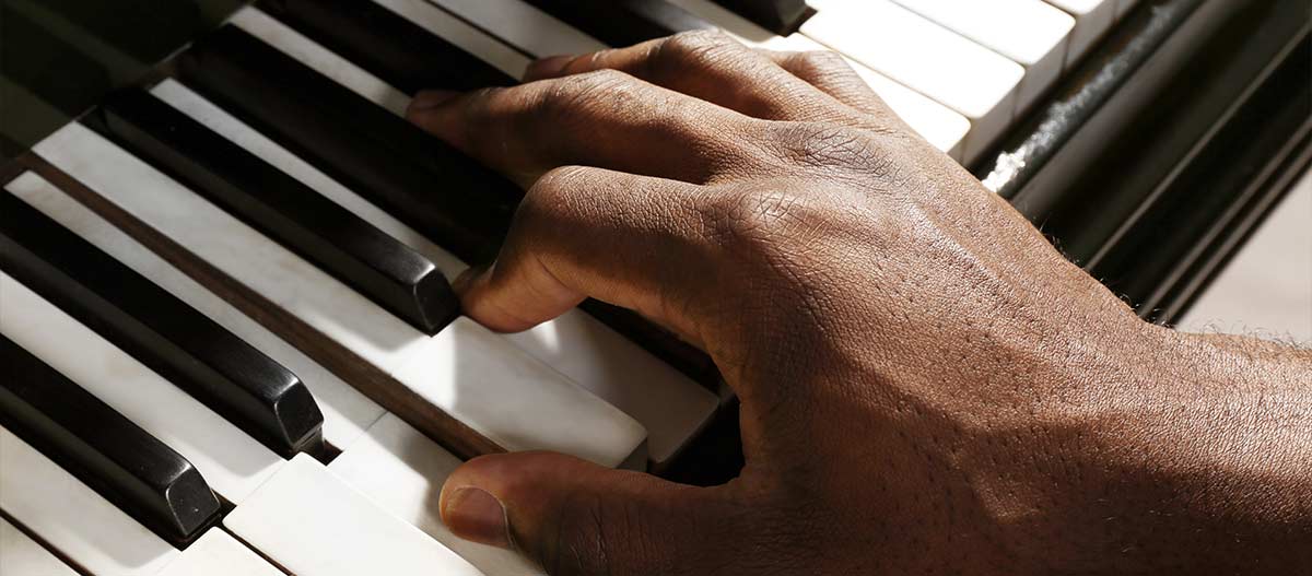Man hand playing piano