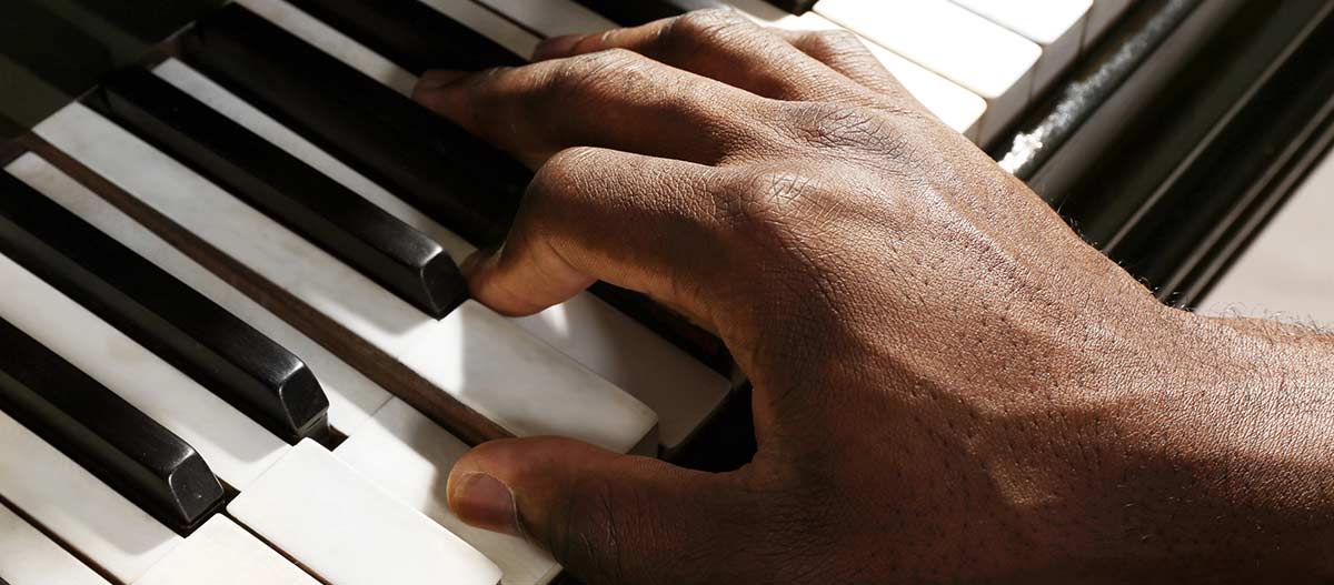 Man hand playing piano