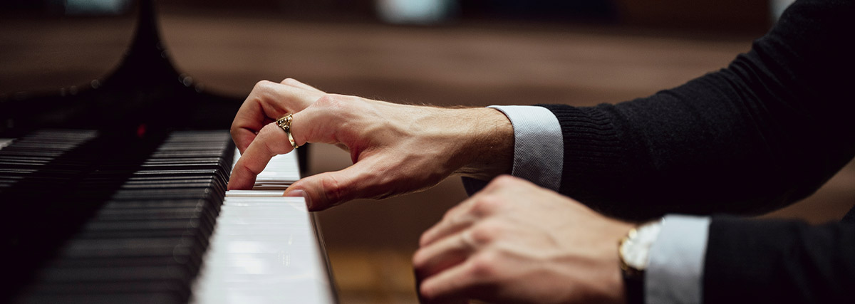 Man hand pressing the piano keys