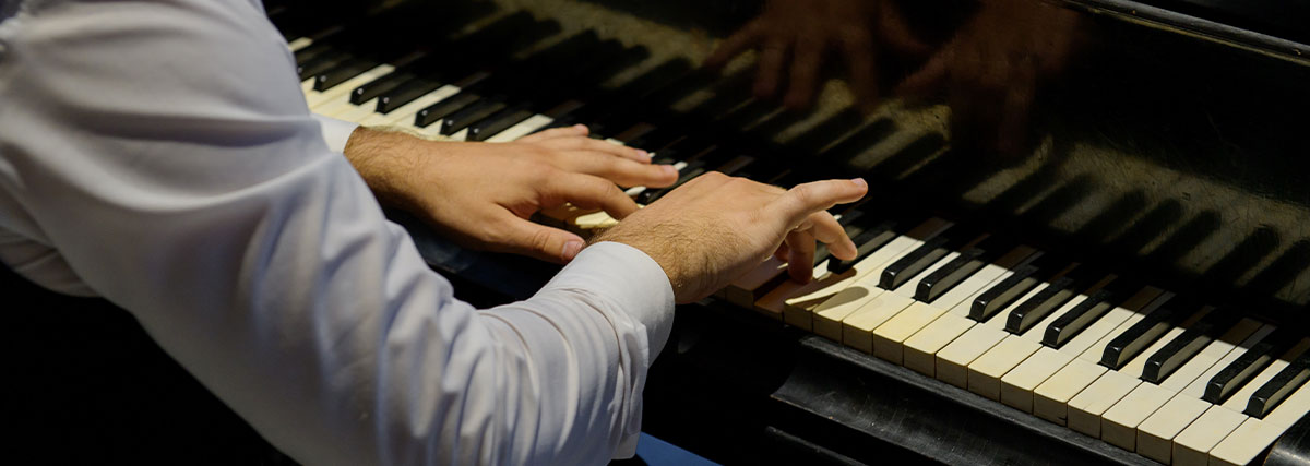 Man in suit playing piano
