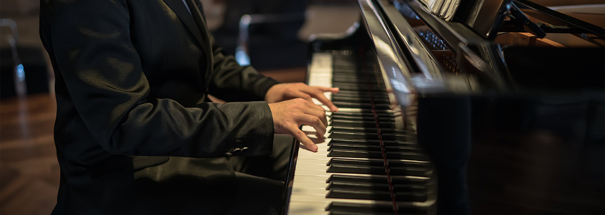 Man in suit playing piano