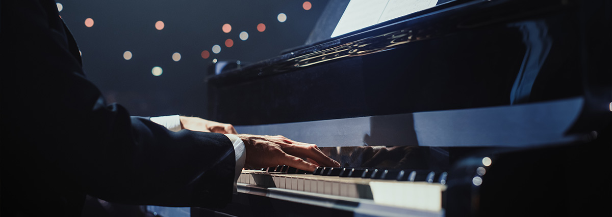 Man in suit playing the piano