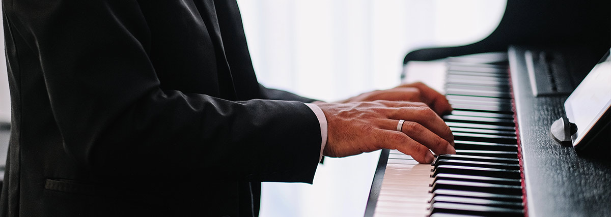 Man in suit playing the piano