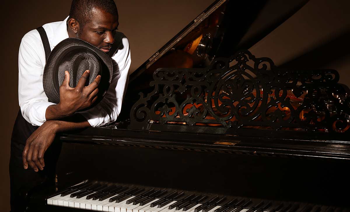 Man leaning and looking at the piano