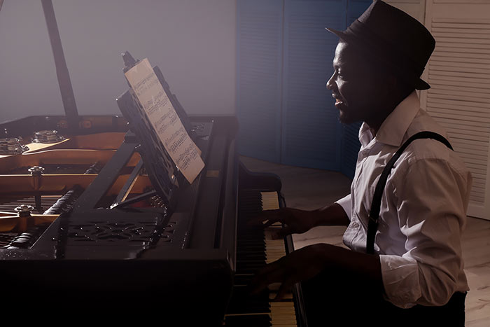 man playing on the grand piano feat