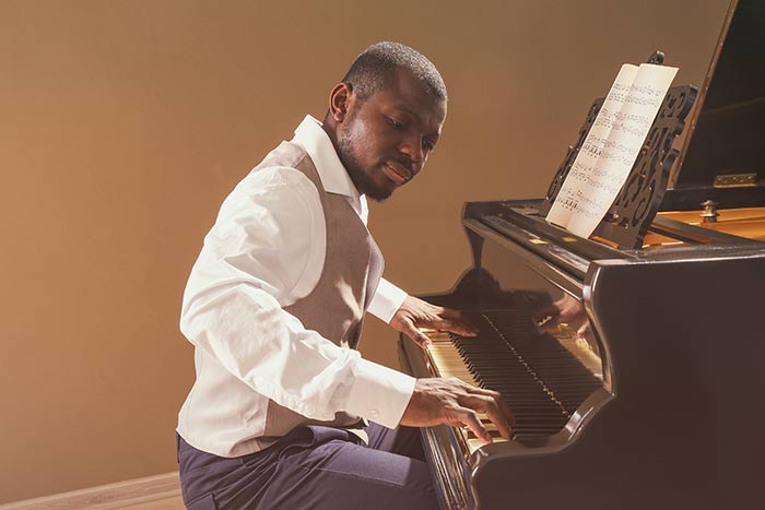 man playing on the grand piano feat