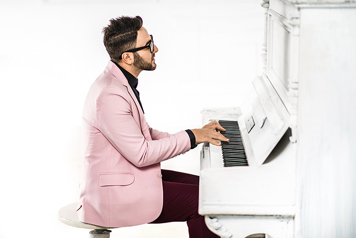 Man playing piano passionately feat