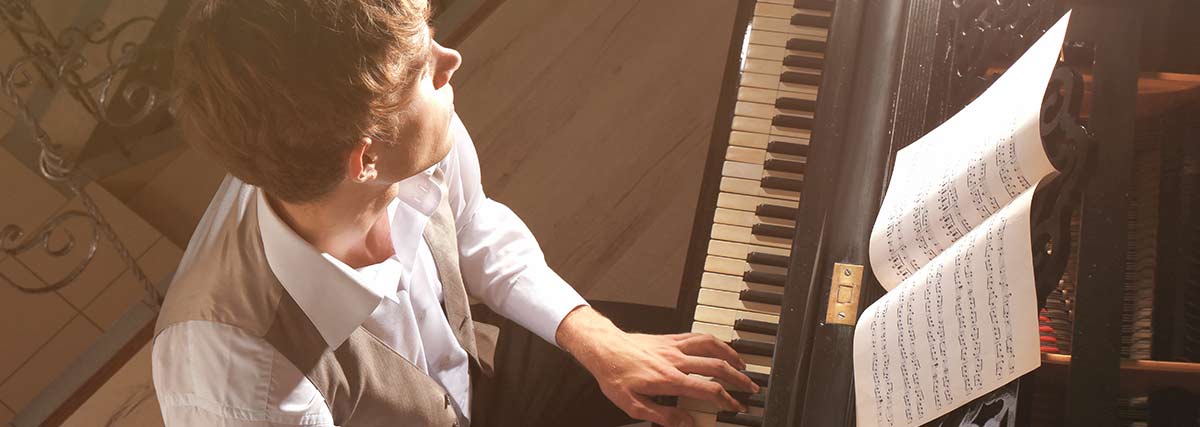 man playing on the grand piano