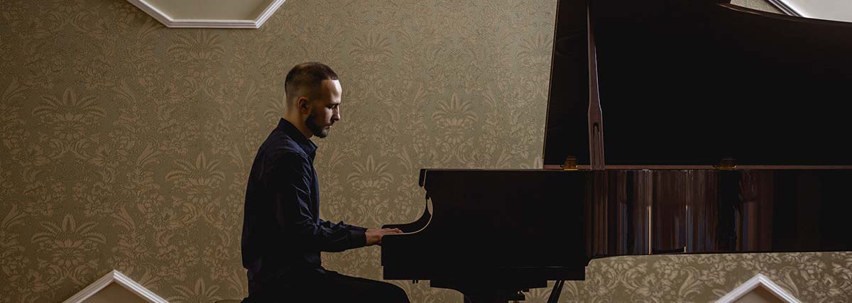 man playing the grand piano