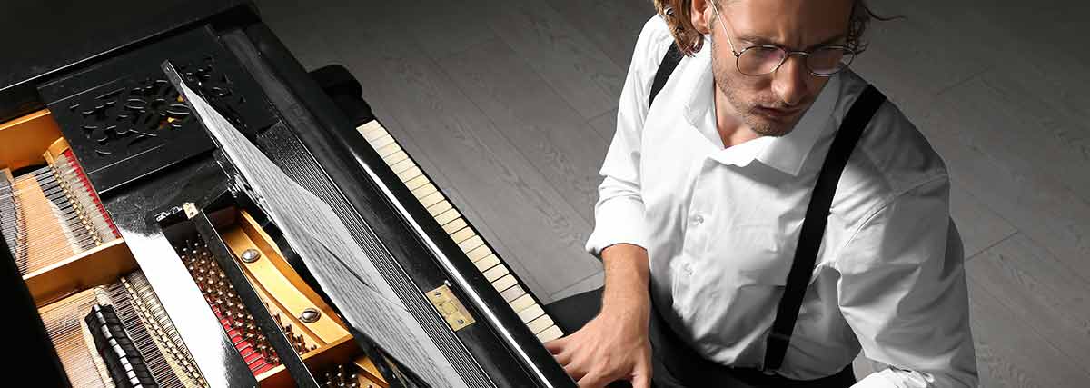 man playing the grand piano