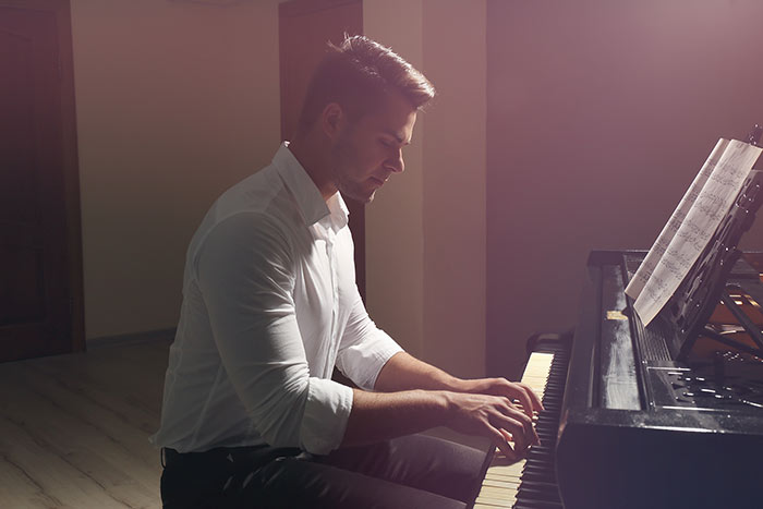 man playing the piano feat
