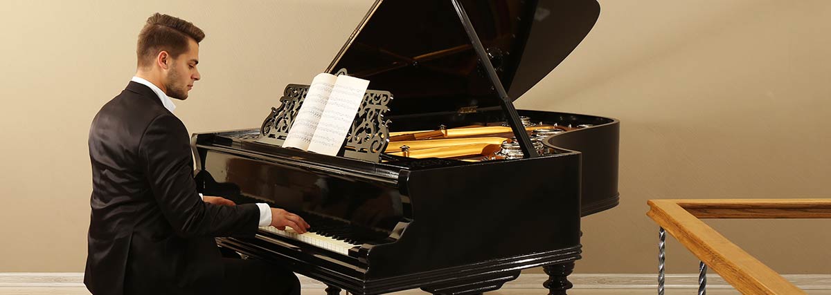 Man practicing the grand piano