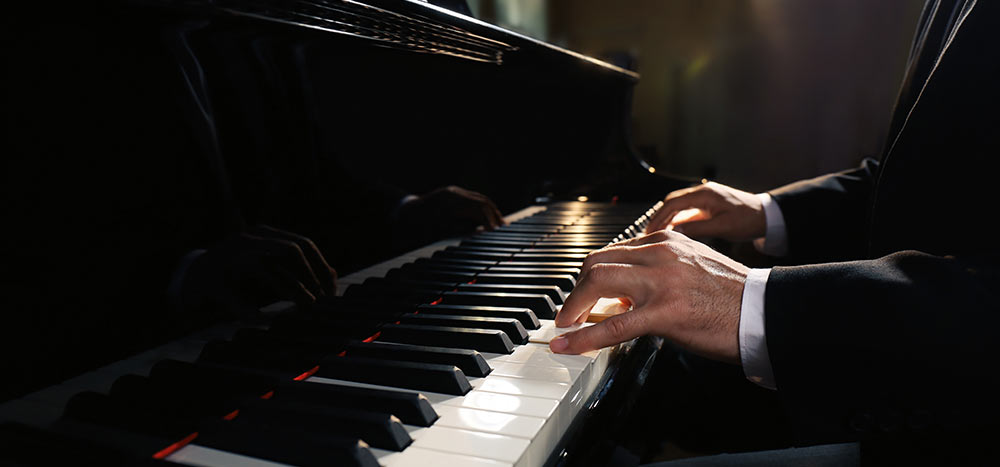 Man's hands on an elegant piano