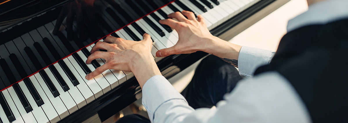 Man's hands on the piano keys
