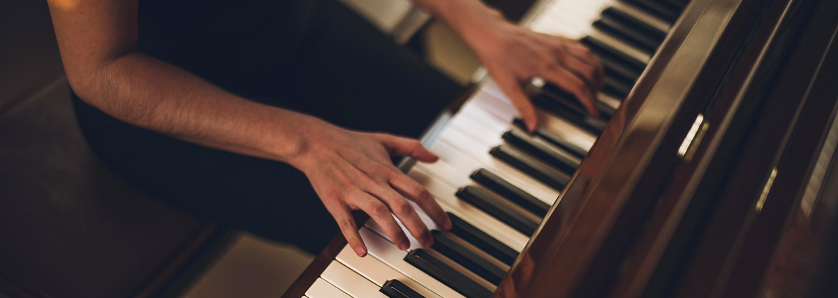Pianist hands on the piano keyboard
