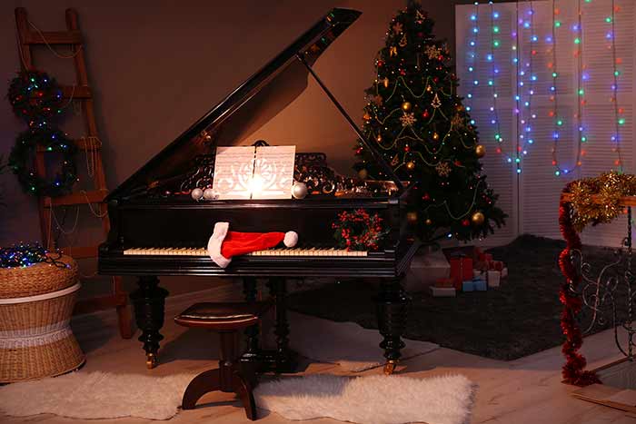 piano with Christmas decorations feat
