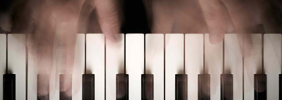 piano keys with blurred hands