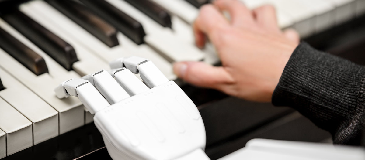 Robot and human hand on piano keyboard