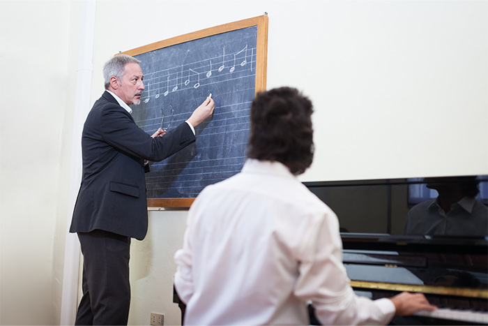 Teacher giving piano lesson feat