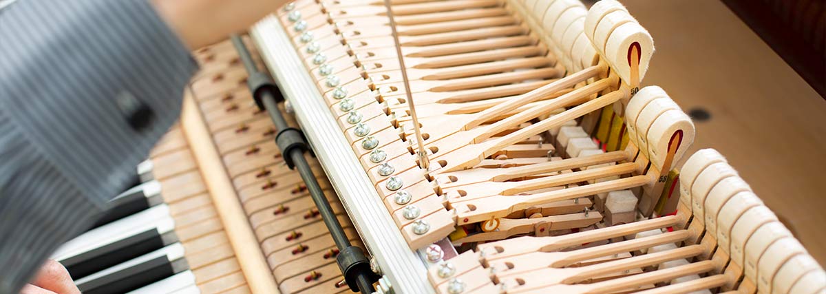 Technician repairing piano