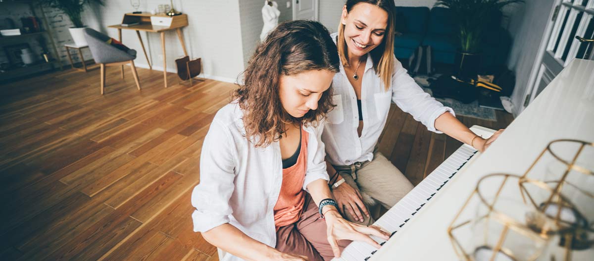 Two ladies playing piano