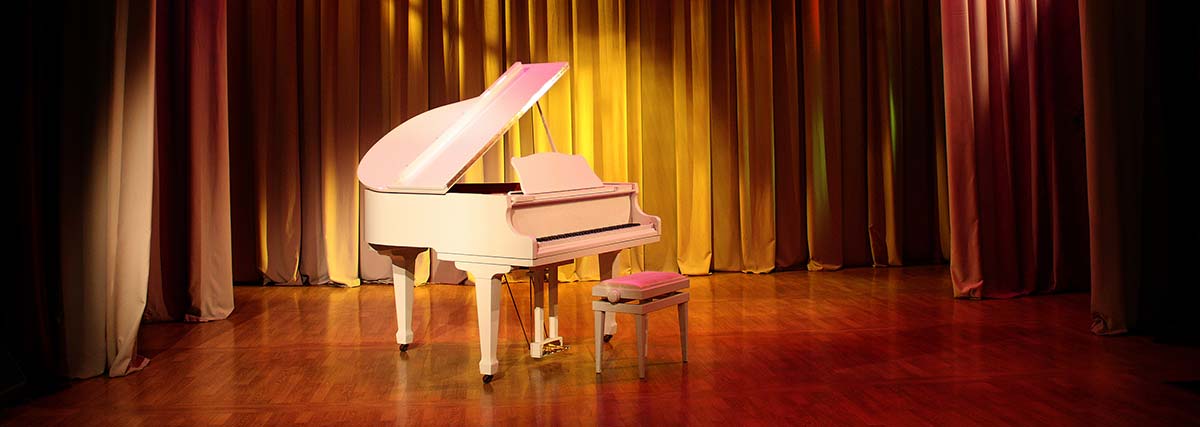 white grand piano on stage