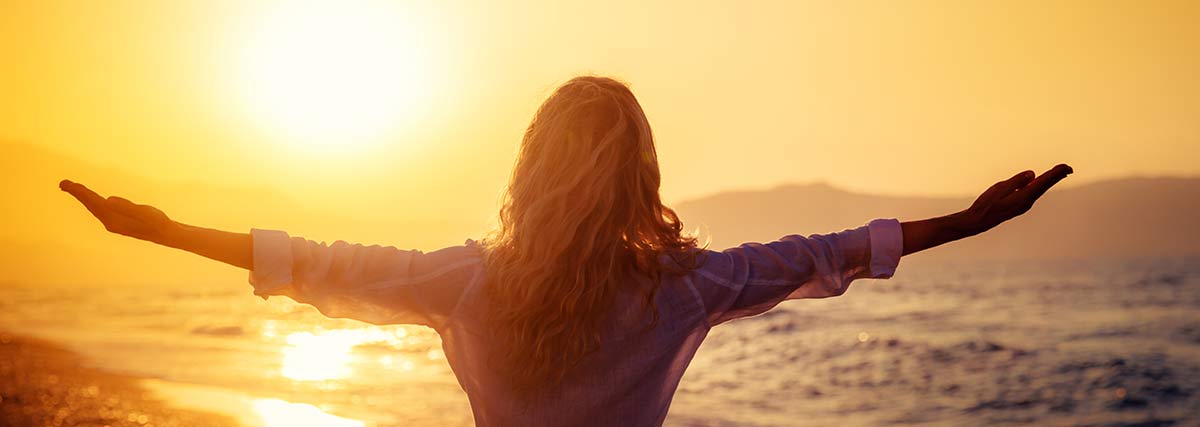 Woman enjoying freedom at the beach on a summer day!