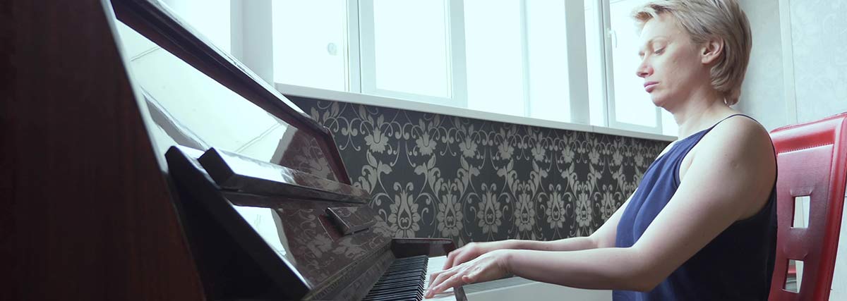woman focused with her piano playing